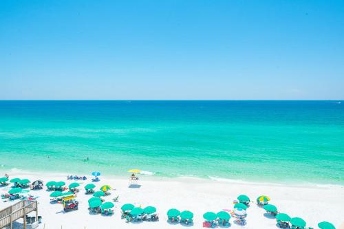 a group of umbrellas and chairs on a beach at The Surf Shack in Destin