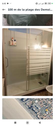 une photo d'une salle de bain avec une porte de douche en verre dans l'établissement Appartement 5 personnes, à Saint-Hilaire-de-Riez