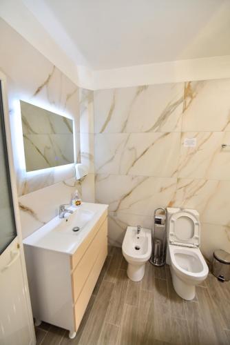a bathroom with a sink and a toilet at Fran's Traditional House in Shkodër