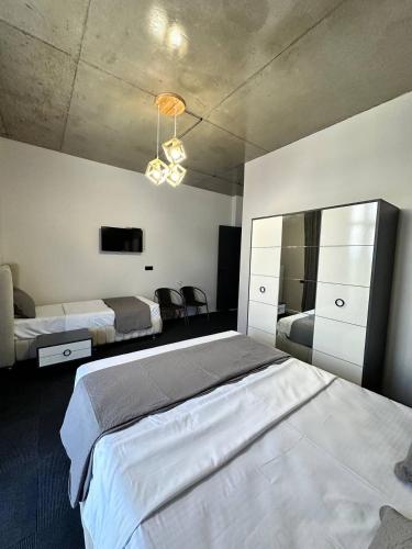a large bedroom with two beds and a chandelier at Hotel black sea in K'obulet'i