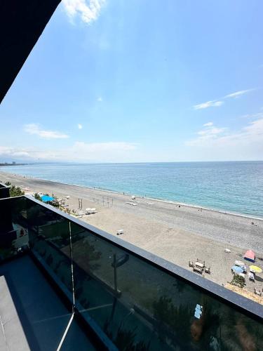 a view of a beach and the ocean from a balcony at Hotel black sea in K'obulet'i