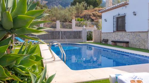 a swimming pool in a yard with a villa at Casa La Fajara 2 Canillas de Aceituno by Ruralidays in Canillas de Aceituno