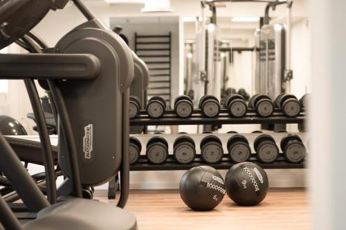 a gym with several rows of dumbbells on display at Quality Hotel The Mill in Malmö