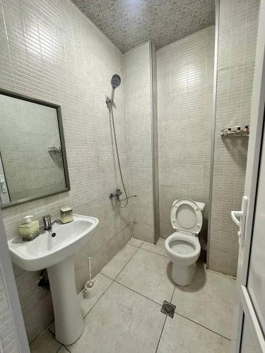 a bathroom with a sink and a toilet at Hotel black sea in K'obulet'i