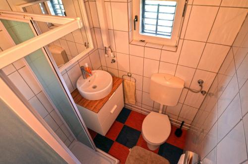 a small bathroom with a toilet and a sink at Holiday Home Campo in Rovinj