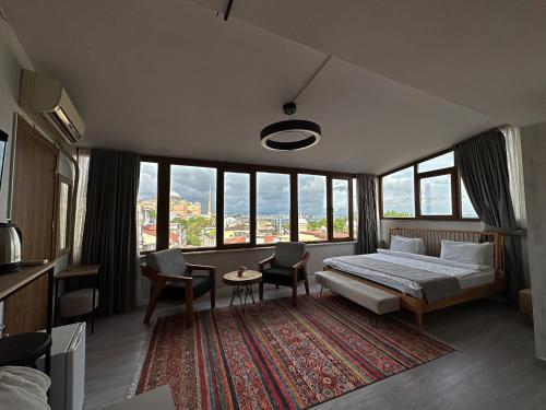 a bedroom with a bed and a table and chairs at Million Old City Apartment in Istanbul