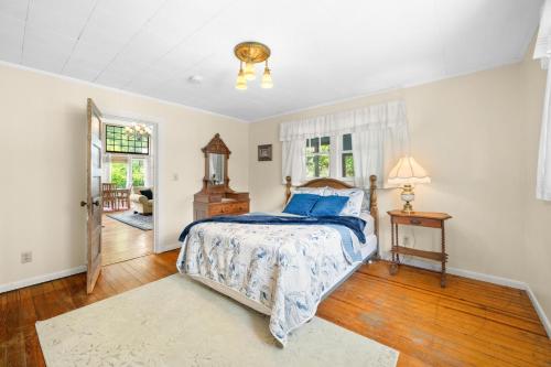 a bedroom with a bed with blue pillows on it at Artist Lane Cottage in Nashville