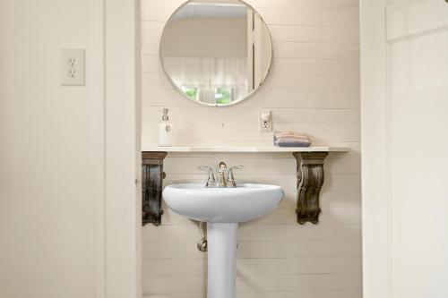 a bathroom with a sink and a mirror at Artist Lane Cottage in Nashville