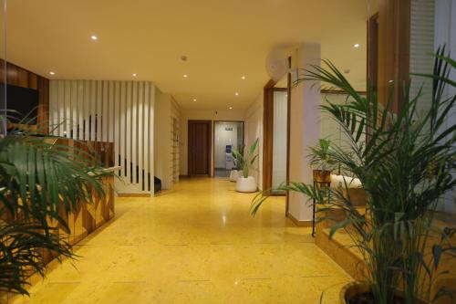 a hallway with potted plants in a building at The Grand Uddhav- A Boutique Hotel in Udaipur