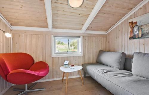 a living room with a couch and a chair at Holiday Home Kragevej in Hirtshals