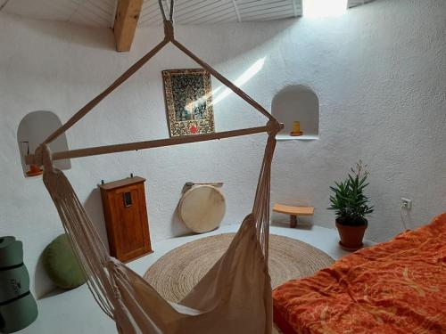 a bedroom with a bed and a hammock at La Petite Tour de Puivert in Puivert