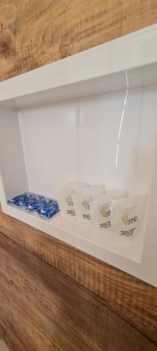 a display case with three boxes of cigarettes at Pousada Ágape duplo in Chapada dos Guimarães