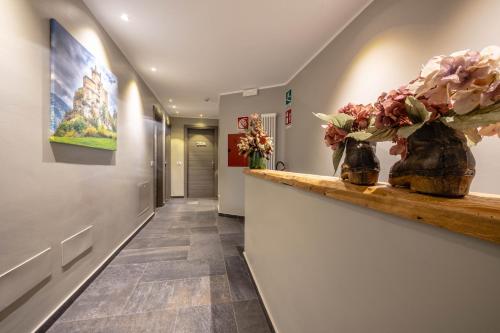 a hallway with flowers in vases on a counter at Monte Emilius in Aosta
