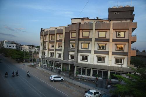 a building on the side of a street next to a road at R Empire Revtree in Dāvangere