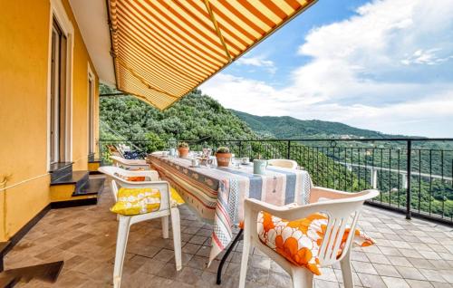 a balcony with a table and chairs and a view at Cozy Home In Sori With House Sea View in Sori