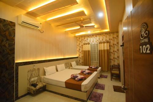 a bedroom with a bed in a room at R Empire Revtree in Dāvangere
