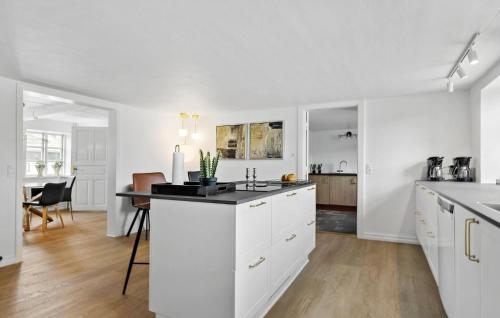 an open kitchen with white cabinets and a counter top at Six-Bedroom Holiday Home In Haderslev in Haderslev