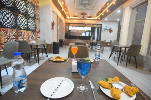 a wooden table with plates of food and drinks on it at R Empire Revtree in Dāvangere