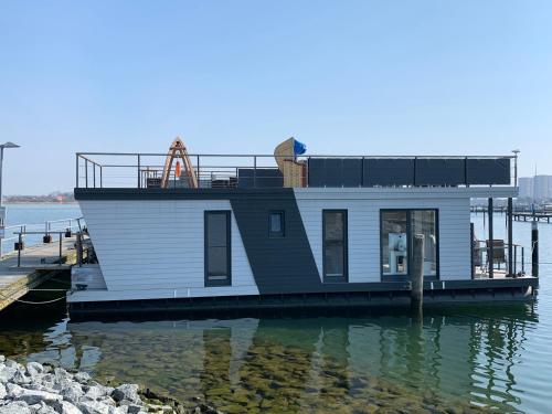 a ferry boat is docked in the water at Hausboot Fehmarn in Fehmarn