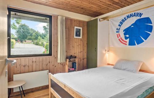 a bedroom with a bed and a window at 4 Bedroom Cozy Home In Vordingborg in Vordingborg