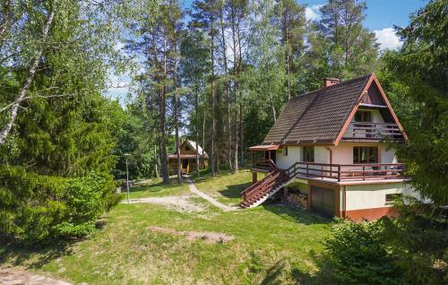a house in the woods with a slide at 2 Bedroom Nice Home In Bobolice in Bobolice