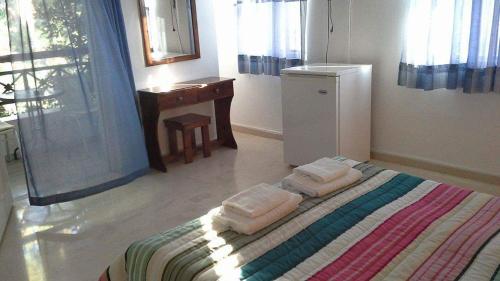 a bedroom with a bed with towels on it at Soldatos Rooms in Marantochori