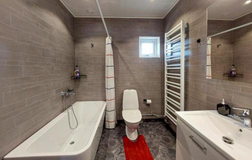 a bathroom with a tub and a toilet and a sink at Amazing Home In Perstorp in Perstorp