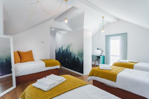 a room with three beds and a desk at BeSmart Residence by Home Sweet Home Aveiro in Aveiro
