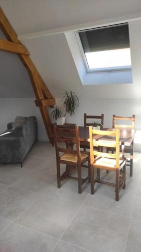 a living room with a table and chairs and a couch at La maison des Peupliers in Hoffen