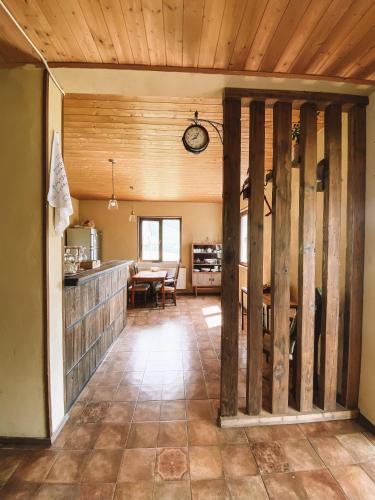 a kitchen with wooden ceilings and a dining room at Arte in Kazbegi in Stepantsminda