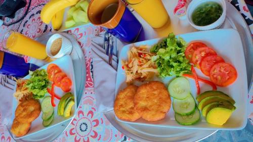 two plates of food with different types of food at Desired View vacation rentals in LʼIvrogne