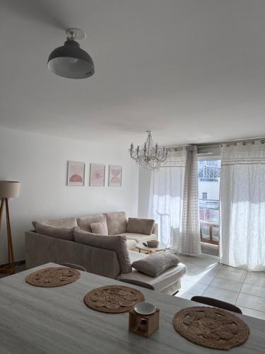 a white living room with a bed and a couch at Appartement au centre de Villeurbanne in Villeurbanne