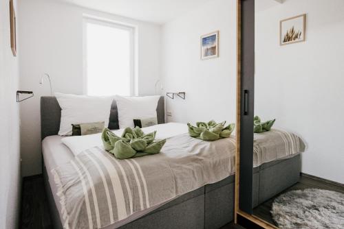 a bedroom with a bed with a mirror at Ferienwohnung Emma in Güntersberge