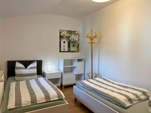 a bedroom with two beds and a dresser at FeWo Wollin Mecklenburg Pool Alte Schule Barlin in Dargun