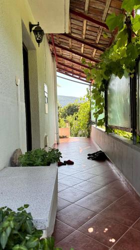 a porch of a building with a window and a patio at Cosy Apartment Sea View in Kumbor in Kumbor