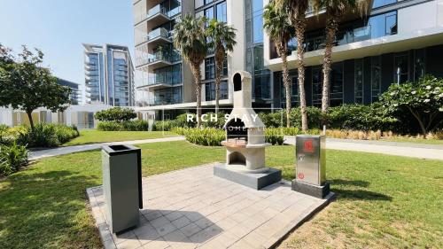 a sculpture in a park in front of a building at Crystal Clear 1BR in Blue Waters with Ain View in Dubai
