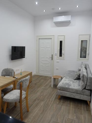 a living room with a couch and a table at DEJA BLUE Cozy Apartments in Durrës