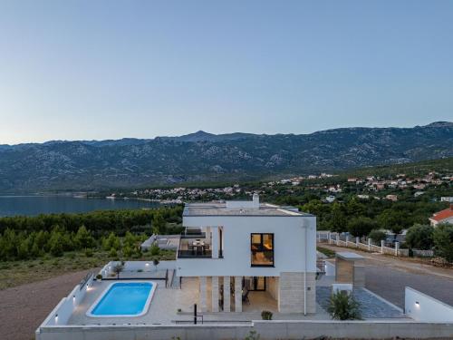 an aerial view of a house with a swimming pool at Villa Malusy ZadarVillas in Rovanjska