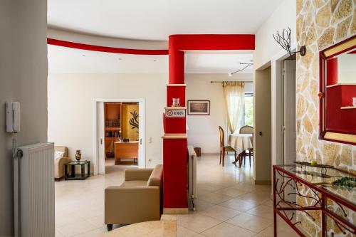 a living room with a red pole in the middle at Villa Nefeli with Private Pool by Konnect in Dassia