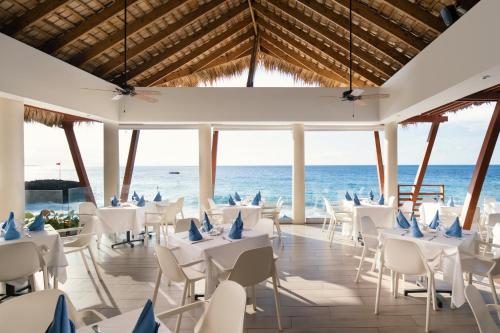 a wedding reception on the beach with white tables and chairs at Select at Casa Marina Adults Only All Inclusive in Sosúa