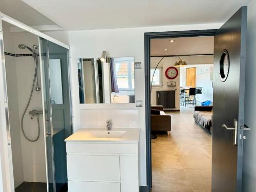 une salle de bain avec un lavabo et une chambre avec un lit dans l'établissement A l Urban de Champagne - Reims, à Reims