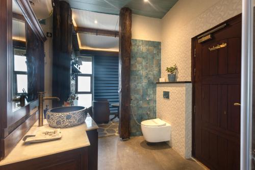 a bathroom with a tub and a toilet and a sink at Jharipani Castle in Mussoorie