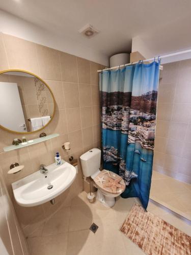 a bathroom with a sink and a toilet and a shower at Студио в Затворен Комплекс Blue in Sozopol