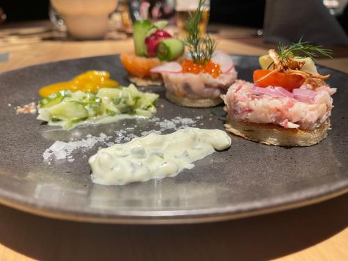 a plate with different types of food on it at ONNO Boutique Hotel & Apartments in Rendsburg