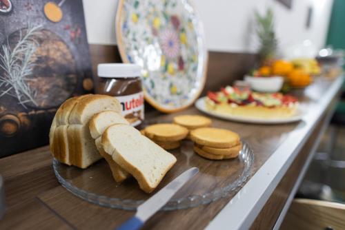 a table with a plate of bread and peanut butter at Etna Hills in Catania