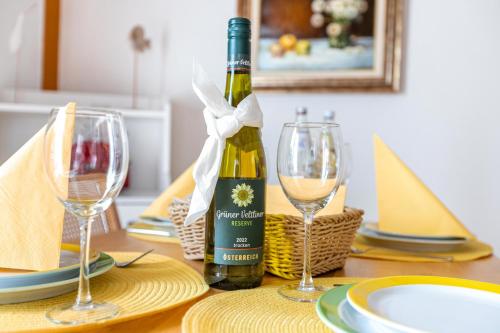a bottle of wine sitting on a table with two glasses at Atlanta Pur in Pellworm