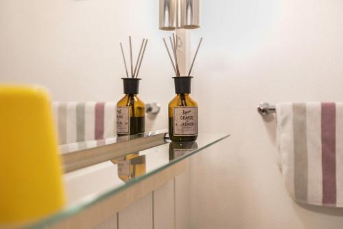 two bottles of essential oils sitting on a counter in a bathroom at Atlanta Pur in Pellworm