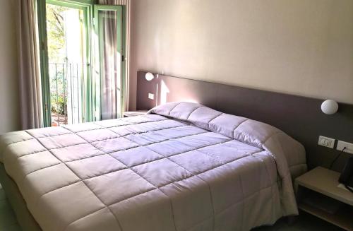 a bedroom with a large bed with a window at Locanda La Cavallina in Brisighella