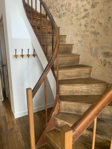 a wooden staircase with wooden railings in a house at Appart à Mémé 2 chambres in Parthenay