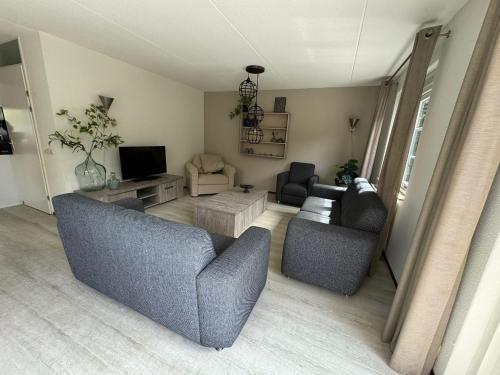 a living room with two couches and a tv at Modern Vakantiehuis op Loopafstand van de Zee in Kamperland in Kamperland
